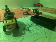 In the midst of a post-apocalyptic Earth devastated by rogue AI weapons, players take control of rugged RC rescue vehicles. As the board game progresses, they must navigate their vehicles across treacherous terrain filled with physical obstacles—collapsed buildings, barricades, debris, and unstable ground.  Each mission on the board game triggers an interactive driving sequence, where players must skillfully maneuver their RC cars to reach stranded survivors and deliver them safely to the last remaining safe zone.  With every successful rescue, players advance in the game, making strategic decisions and overcoming both tactical and physical challenges to ensure humanity’s survival.