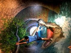 AR of a crocodile jumping out of a waterfall and attacking